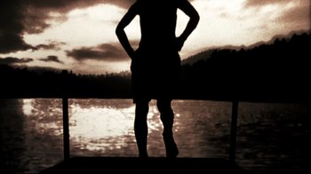 Movie still from “The Dead Girl” (2006), directed by Karen Moncrieff – A man standing on a dock near a body of water; Wide shot, Low angle