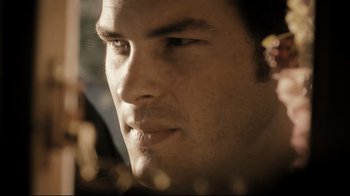 Movie still from “The Dead Girl” (2006), directed by Karen Moncrieff – A man's face in a dark room; Extreme Close Up shot, Over the shoulder angle