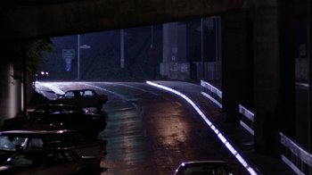 Movie still from “The Dead Pool” (1988), directed by Buddy Van Horn – Cars parked on the side of a road at night; Extreme Wide shot, High angle