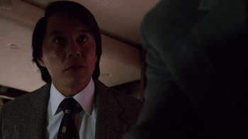 Movie still from “The Dead Pool” (1988), directed by Buddy Van Horn – A man wearing a suit and tie talking to another man; Close Up shot, Over the shoulder angle