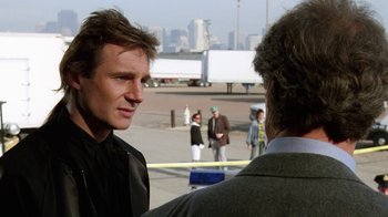 Movie still from “The Dead Pool” (1988), directed by Buddy Van Horn – A man standing next to another man in a parking lot; Close Up shot, Over the shoulder angle