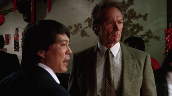 Movie still from “The Dead Pool” (1988), directed by Buddy Van Horn – A man and a woman standing next to each other in a room; Close Up shot, Low angle