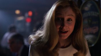Movie still from “The Dead Pool” (1988), directed by Buddy Van Horn – A woman with long blonde hair is looking surprised; Close Up shot, Over the shoulder angle