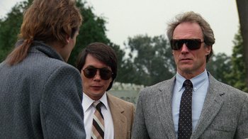 Movie still from “The Dead Pool” (1988), directed by Buddy Van Horn – A group of men standing next to each other wearing sunglasses; Close Up shot, Over the shoulder angle