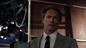 Movie still from “The Dead Pool” (1988), directed by Buddy Van Horn – A person wearing a suit and tie; Close Up shot, Low angle