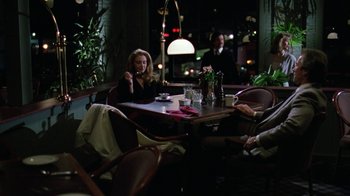 Movie still from “The Dead Pool” (1988), directed by Buddy Van Horn – A group of people sitting at a table in a restaurant; Wide shot, High angle