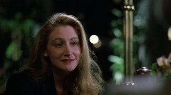 Movie still from “The Dead Pool” (1988), directed by Buddy Van Horn – A person sitting at a table; Close Up shot, Over the shoulder angle