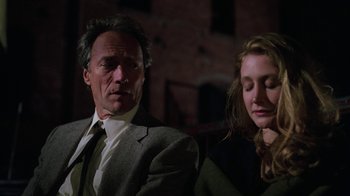 Movie still from “The Dead Pool” (1988), directed by Buddy Van Horn – A man and a woman sitting next to each other in a dark room; Close Up shot, Low angle
