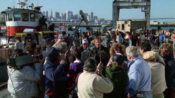 Movie still from “The Dead Pool” (1988), directed by Buddy Van Horn – A group of people standing on top of a dock; Wide shot, Over the shoulder angle