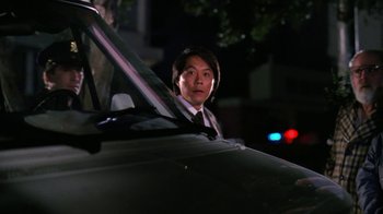 Movie still from “The Dead Pool” (1988), directed by Buddy Van Horn – A man in a suit sitting in the back seat of a car; Close Up shot, Over the shoulder angle