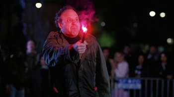 Movie still from “The Dead Pool” (1988), directed by Buddy Van Horn – A man holding a red light in his right hand; Medium shot, Low angle