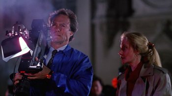 Movie still from “The Dead Pool” (1988), directed by Buddy Van Horn – A man and a woman standing next to each other; Close Up shot, Low angle