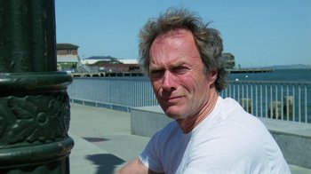 Movie still from “The Dead Pool” (1988), directed by Buddy Van Horn – A person wearing a white t - shirt; Close Up shot, Low angle