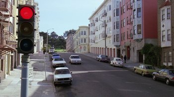 Movie still from “The Dead Pool” (1988), directed by Buddy Van Horn – Cars parked on the side of the road in a city; Extreme Wide shot, High angle