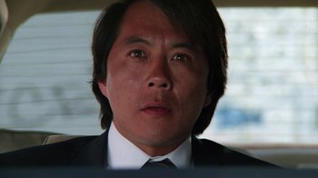 Movie still from “The Dead Pool” (1988), directed by Buddy Van Horn – A person wearing a suit and tie; Close Up shot, Low angle