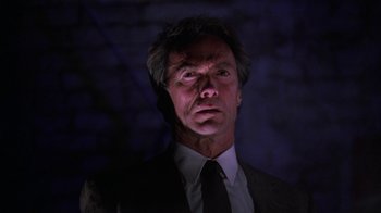 Movie still from “The Dead Pool” (1988), directed by Buddy Van Horn – A person wearing a suit and tie; Close Up shot, Low angle