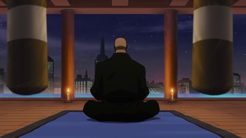 Movie still from “The Death and Return of Superman” (2019), directed by Sam Liu – A man is sitting in the middle of the night; Wide shot, Low angle