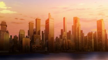 Movie still from “The Death and Return of Superman” (2019), directed by Sam Liu – A view of a city skyline at sunset with the sun setting; Extreme Wide shot, Low angle