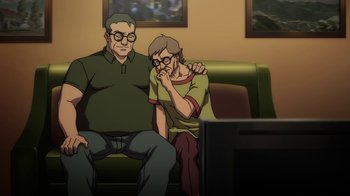 Movie still from “The Death and Return of Superman” (2019), directed by Sam Liu – An older man and a younger man sitting on a couch; Medium shot, High angle