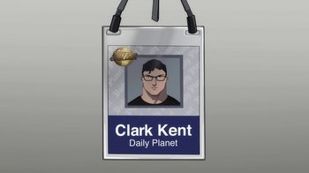 Movie still from “The Death and Return of Superman” (2019), directed by Sam Liu – A badge with a picture of a man with glasses; Close Up shot, Overhead angle