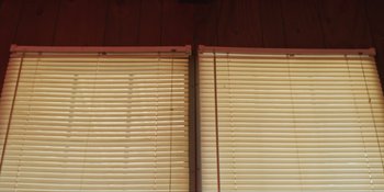 Movie still from “The Death of Dick Long” (2019), directed by Daniel Scheinert – A pair of white blinds on a wooden wall; Medium shot, Low angle