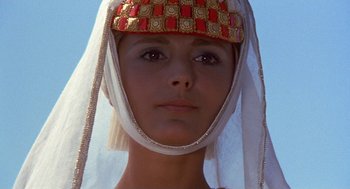 Movie still from “The Decameron” (1971), directed by Pier Paolo Pasolini – A person wearing a headdress; Close Up shot, Low angle