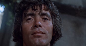 Movie still from “The Decameron” (1971), directed by Pier Paolo Pasolini – A man's face in a dark room; Close Up shot, Low angle
