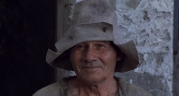 Movie still from “The Decameron” (1971), directed by Pier Paolo Pasolini – An old man wearing a hat and looking at the camera; Close Up shot, Low angle