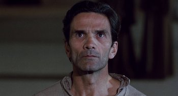 Movie still from “The Decameron” (1971), directed by Pier Paolo Pasolini – A person looking at the camera; Close Up shot, Low angle