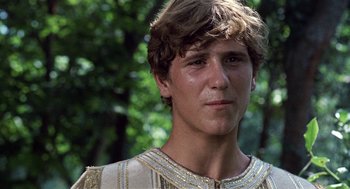 Movie still from “The Decameron” (1971), directed by Pier Paolo Pasolini – A young man wearing a gold and white costume; Close Up shot, Low angle