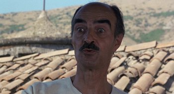 Movie still from “The Decameron” (1971), directed by Pier Paolo Pasolini – A person with a surprised look on his face; Close Up shot, Low angle