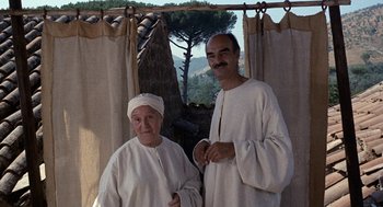 Movie still from “The Decameron” (1971), directed by Pier Paolo Pasolini – A man and a woman standing next to each other; Medium shot, Low angle