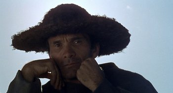 Movie still from “The Decameron” (1971), directed by Pier Paolo Pasolini – A person wearing a hat; Close Up shot, Low angle