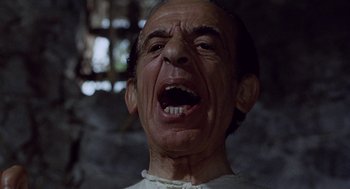 Movie still from “The Decameron” (1971), directed by Pier Paolo Pasolini – An old man with an open mouth and teeth; Close Up shot, Low angle