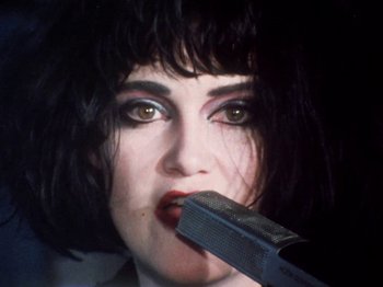 Movie still from “The Decline of Western Civilization” (1981), directed by Penelope Spheeris – A person with a microphone; Close Up shot, Low angle