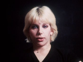 Movie still from “The Decline of Western Civilization” (1981), directed by Penelope Spheeris – A woman with blonde hair wearing a black shirt; Close Up shot, Low angle