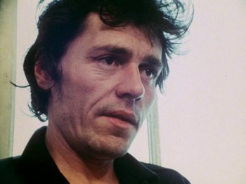 Movie still from “The Decline of Western Civilization” (1981), directed by Penelope Spheeris – A person wearing a black shirt; Close Up shot, Low angle