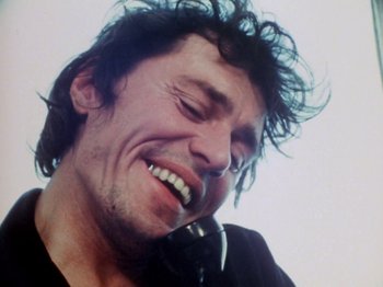 Movie still from “The Decline of Western Civilization” (1981), directed by Penelope Spheeris – A person with headphones on; Close Up shot, Low angle