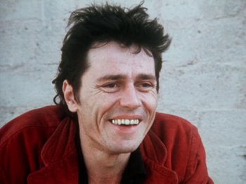 Movie still from “The Decline of Western Civilization” (1981), directed by Penelope Spheeris – A person with a red jacket; Close Up shot, Low angle