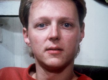 Movie still from “The Decline of Western Civilization” (1981), directed by Penelope Spheeris – A person wearing a red shirt; Close Up shot, High angle