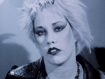 Movie still from “The Decline of Western Civilization” (1981), directed by Penelope Spheeris – A person wearing a leather jacket; Close Up shot, Low angle