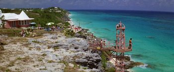 Movie still from “The Deep” (1977), directed by Peter Yates – A view of the ocean from the top of a cliff; Extreme Wide shot, High angle