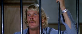 Movie still from “The Deep” (1977), directed by Peter Yates – A person holding a pole; Close Up shot, Low angle