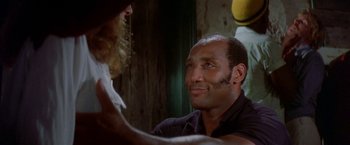 Movie still from “The Deep” (1977), directed by Peter Yates – A man with a long beard and a man with long hair; Close Up shot, Over the shoulder angle