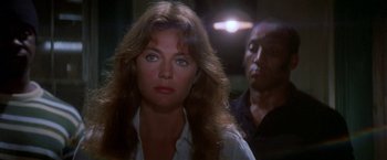 Movie still from “The Deep” (1977), directed by Peter Yates – A person wearing a white shirt; Close Up shot, Over the shoulder angle