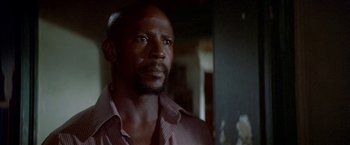 Movie still from “The Deep” (1977), directed by Peter Yates – A person wearing a dress shirt; Close Up shot, Low angle