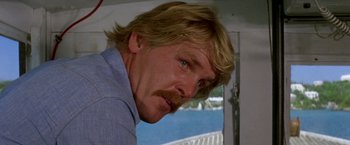 Movie still from “The Deep” (1977), directed by Peter Yates – A person with a mustache; Close Up shot, Low angle