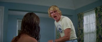 Movie still from “The Deep” (1977), directed by Peter Yates – A man with blonde hair is yelling at a woman; Medium shot, Over the shoulder angle