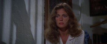 Movie still from “The Deep” (1977), directed by Peter Yates – A person with long hair looking at the camera; Close Up shot, Over the shoulder angle