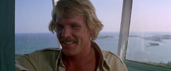 Movie still from “The Deep” (1977), directed by Peter Yates – A person with long blonde hair; Close Up shot, Low angle